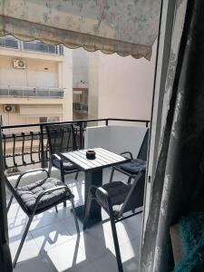 a balcony with a table and chairs on a balcony at DZ Apartment AXD in Alexandroupoli
