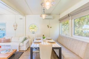 a living room with a table and a couch at Očarujúci Houseboat na Dunaji in Bratislava