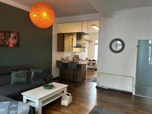 a living room with a couch and a table at Stangenberg`s City Loft in Hameln