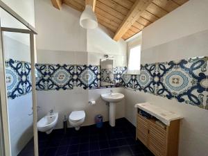 a bathroom with a toilet and a sink at Casa D'Angelo in Cossignano +18 photos