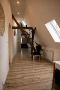 Cette chambre est dotée d'un escalier avec une chaise et une lucarne. dans l'établissement Belles combles alsaciennes au centre de Strasbourg, à Strasbourg