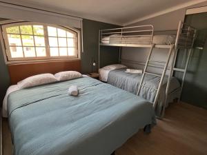 a bedroom with two bunk beds and a window at Sintra Breeze - Sun, Pool & Kitchen in Mem Martins +26 photos