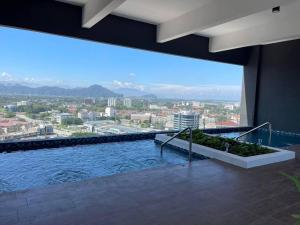 a large swimming pool with a view of a city at Ipoh City The Horizon Your Ultimate Relaxing Gateaway By Hh Suite in Ipoh