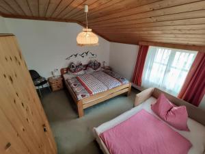 a bedroom with a bed and a couch at Apartment with mountain view near centre in Maria Alm am Steinernen Meer