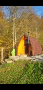 a small brown building with a red roof at Domek Wilcza Wola 2 in Górzanka +6 photos