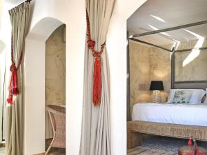 a bedroom with a canopy bed and a table at Cozy three bedroom villa with Es Vedra views! in Cala Vadella