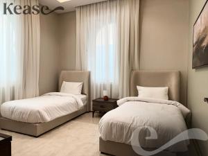 a bedroom with two beds and a window at Kease Al-Mutamarat A-6 Timeless History XZ37 in Riyadh