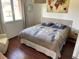 a bedroom with a bed with blue and white sheets at Ô Pas-Sage - Maison d'Hôtes in Gousse +35 photos
