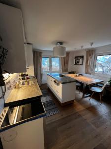 a kitchen and dining room with a table and a counter top at Flat Tom in Schwaighof