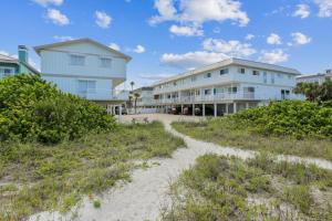a pathway leading to a building on the beach at Gulfside Villas 6 in Clearwater Beach