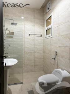 a bathroom with a shower and a toilet and a sink at Kease Al-Mutamarat A-3 Timeless History GX37 in Riyadh
