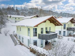 ein Haus ist mit Schnee bedeckt in der Unterkunft Landal Salztal Paradies in Bad Sachsa