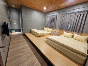een slaapkamer met 2 bedden en een tv. bij 正記製茶所民宿 in Le-yeh