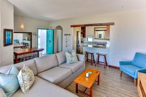 a living room with a couch and a table at 10 AKROTIRI, SANTORINI ESTATE - Families only in Ballito