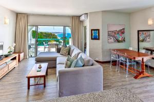 a living room with a couch and a table at 10 AKROTIRI, SANTORINI ESTATE - Families only in Ballito