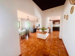 a living room with a table and a dining room at La Asomada Suite Moon Lanzarote in Tías