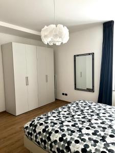 a bedroom with a large bed and a mirror at Ophelia Leon Charme&Relax in Bergamo