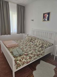 a white bed in a room with a window at Apartments in Zalakaros 48126 in Zalakaros