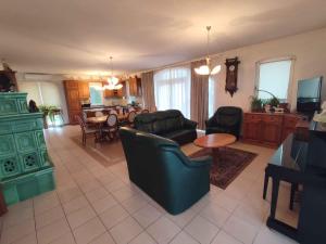 a living room with a couch and a table at Holiday home in Balatonboglar 48107 in Balatonboglár
