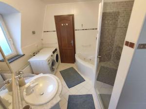 a bathroom with a sink and a toilet and a shower at Holiday home in Balatonboglar 48107 in Balatonboglár +37 photos