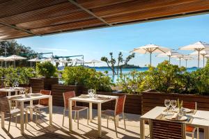 a patio with tables and chairs and umbrellas at Apartment in Rovinj - Istrien 47029 in Rovinj