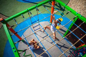due bambini che giocano in una gabbia di battuta in un parco giochi di Apartment in Rovinj - Istrien 47029 a Rovigno (Rovinj)
