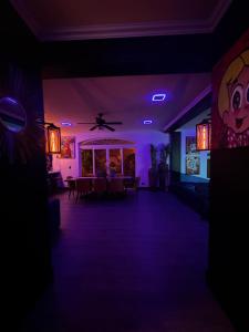 um quarto escuro com luzes roxas e uma sala de jantar em Luxury Condo at Los Sueños Resort & Marina em La Mona