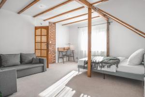 a living room with a bed and a couch at Tuyo Casa Sarabandy in Warsaw