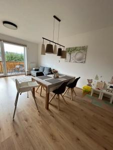 a living room with a table and chairs and a couch at Kašperky in Kašperské Hory