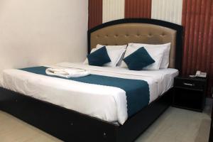a bedroom with a large bed with towels on it at Hotel Anand in Haridwār