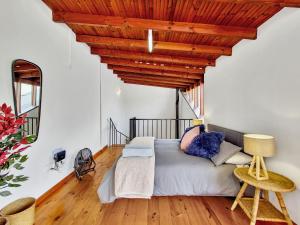 a bedroom with a bed with a wooden ceiling at Braai, Outdoor dining area, workstation, Fast Wi-Fi in Cape Town