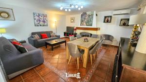 a living room with a couch and a table at Villa Laura in Alhaurín el Grande