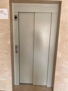 a silver elevator in a building with a sign on it at appart luxe CORALIA 34 IL 7 in Oujda