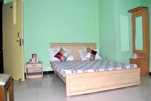 a bedroom with a wooden bed with pillows on it at Hotel Viren Plaza Inn Agra in Agra
