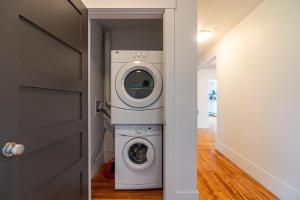 a washer and dryer in a hallway next to a door at Beautiful & Spacious Apt #101 in Halifax