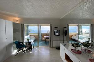a living room with a view of the ocean at 06BH - Beautiful seafront studio in Saint-Laurent-du-Var