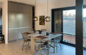 a kitchen with a table and chairs and a large window at 2 Bedroom Gorgeous Apartment In Stockholm in Stockholm