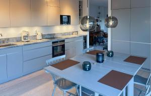 a kitchen with a blue table with chairs in it at 2 Bedroom Cozy Apartment In Stockholm in Stockholm
