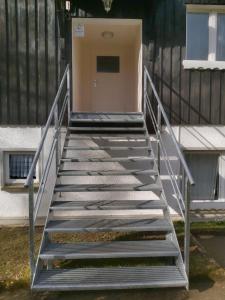 a staircase leading up to a building with a door at BodeBude in Thale