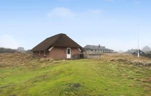 a small house on a grassy hill with at Beautiful Home In Fan With Wi-fi in Fanø