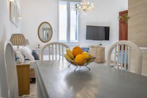 a bowl of fruit on a dining room table at Cozy Carisma Lodging - Central, New and Independent Studio Apartment in Sliema