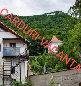 a sign for a mountain with a house on it at Downtown Hostel in Braşov