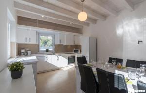 a kitchen and dining room with a table and chairs at Lavanda in Premantura