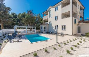 a villa with a swimming pool and a house at Lavanda in Premantura