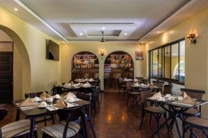 a restaurant with tables and chairs and a bar at Makaazi Nyali in Mombasa