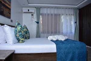 a bedroom with a bed with towels on it at Makaazi Nyali in Mombasa