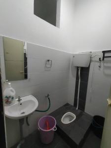 a small bathroom with a sink and a toilet at A YIE HOMESTAY in Kuantan +20 photos