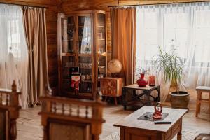 a living room with a china cabinet and a table at Căsuța ta de la munte in Broşteni