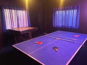 a ping pong table with ping pong balls on it at Rayyan Beach House in Karachi