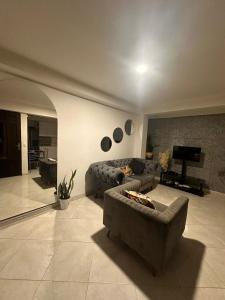 Sala de estar con 2 sofás y TV en Amplio y lindo apartamento, en Medellín